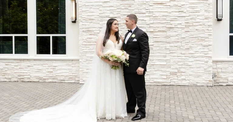 Wedding photography of bride and groom in front of venue in RI